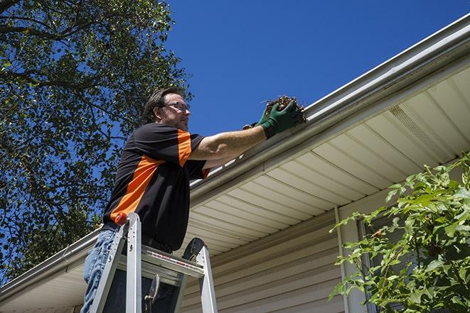 an experienced handyman fixing a gutter issue in Ballard CA