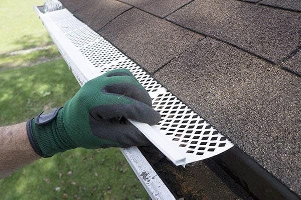 installing gutter guards can improve the overall appearance of your home by keeping the gutters clean and debris-free